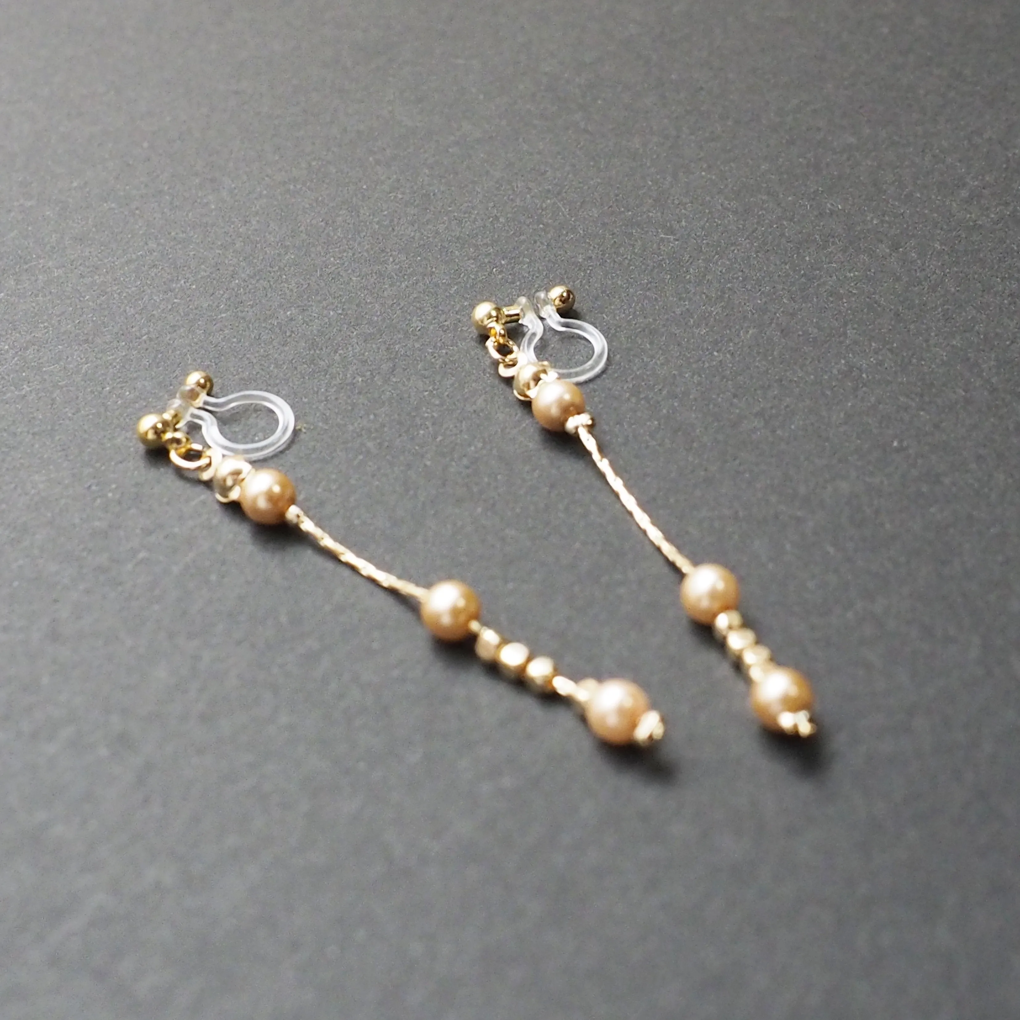 Dangle orange pearls & gold chain invisible clip on earrings