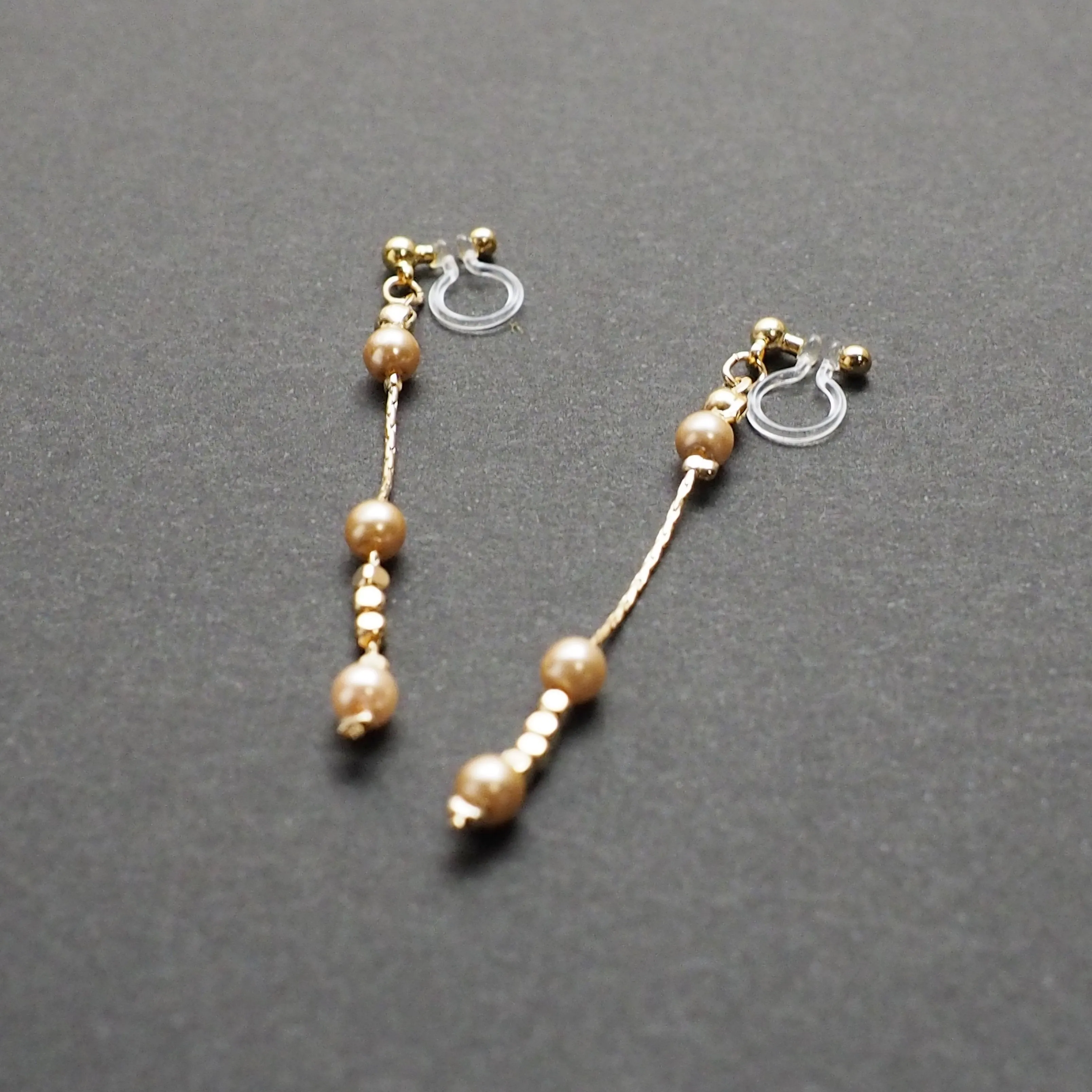 Dangle orange pearls & gold chain invisible clip on earrings